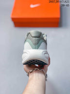 Rear view showing the padded heel, layered upper panels, white midsole, and outsole.