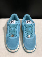 Front view of the pair showing the perforated light blue toe boxes, lace-up fastening, and tongue branding.