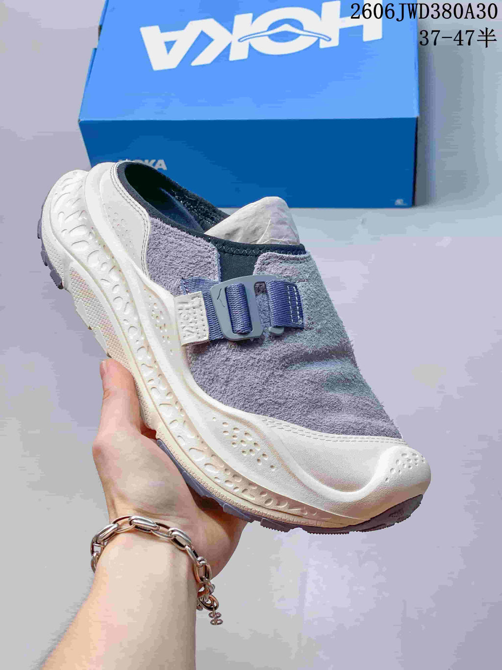 Angled view of a gray and cream HOKA Ora Primo EXT mule shoe
