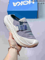 Angled view of a gray and cream HOKA Ora Primo EXT mule shoe