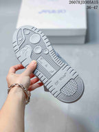 Close view of the patterned gray rubber outsole with circular traction elements and textured tread.