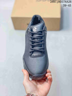 Top view of the black sneaker showing the laces, perforated side panel, padded tongue, and BIOM branding.