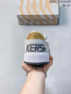 Rear view of the white sneaker showing the large heel lettering and gold glitter heel panel.