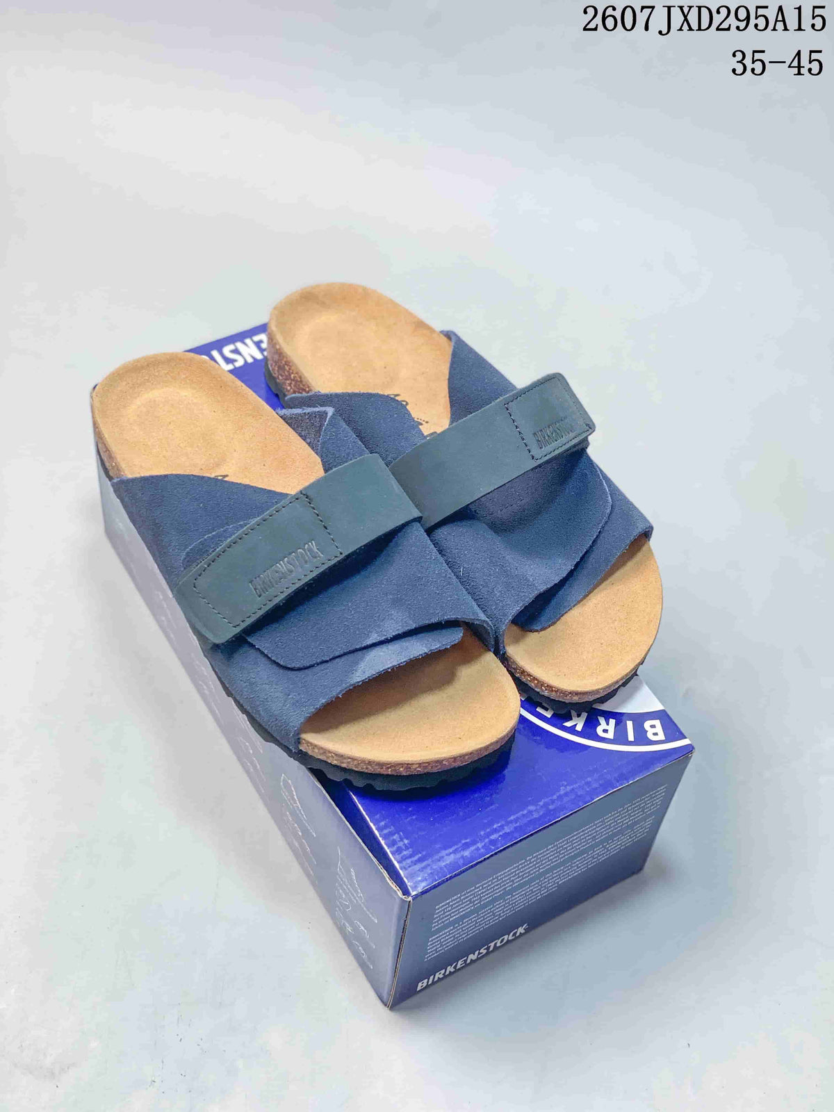 Pair of navy Birkenstock sandals displayed on a branded shoebox, with style code 2607JXD295A15 and size range 35–45 shown above.