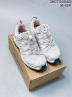 Pair of white Salomon XA PRO 3D sneakers with pink and teal accents displayed on a Salomon shoebox; image text shows style code 2607JYD100A20 and size range 36–45.