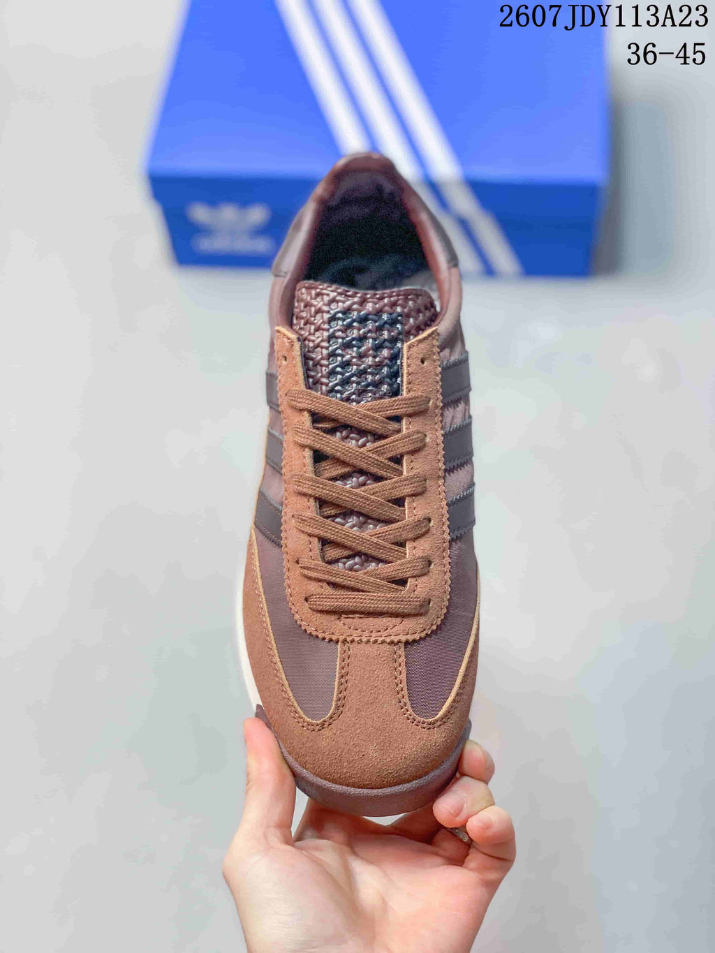 Top view of the brown lace-up adidas sneaker showing the textured tongue, tonal laces, and contrast upper panels.