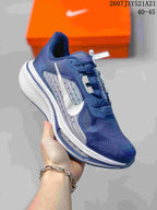 Three-quarter side view of the navy and white sneaker showing the Swoosh and visible Air Zoom marking on the midsole.