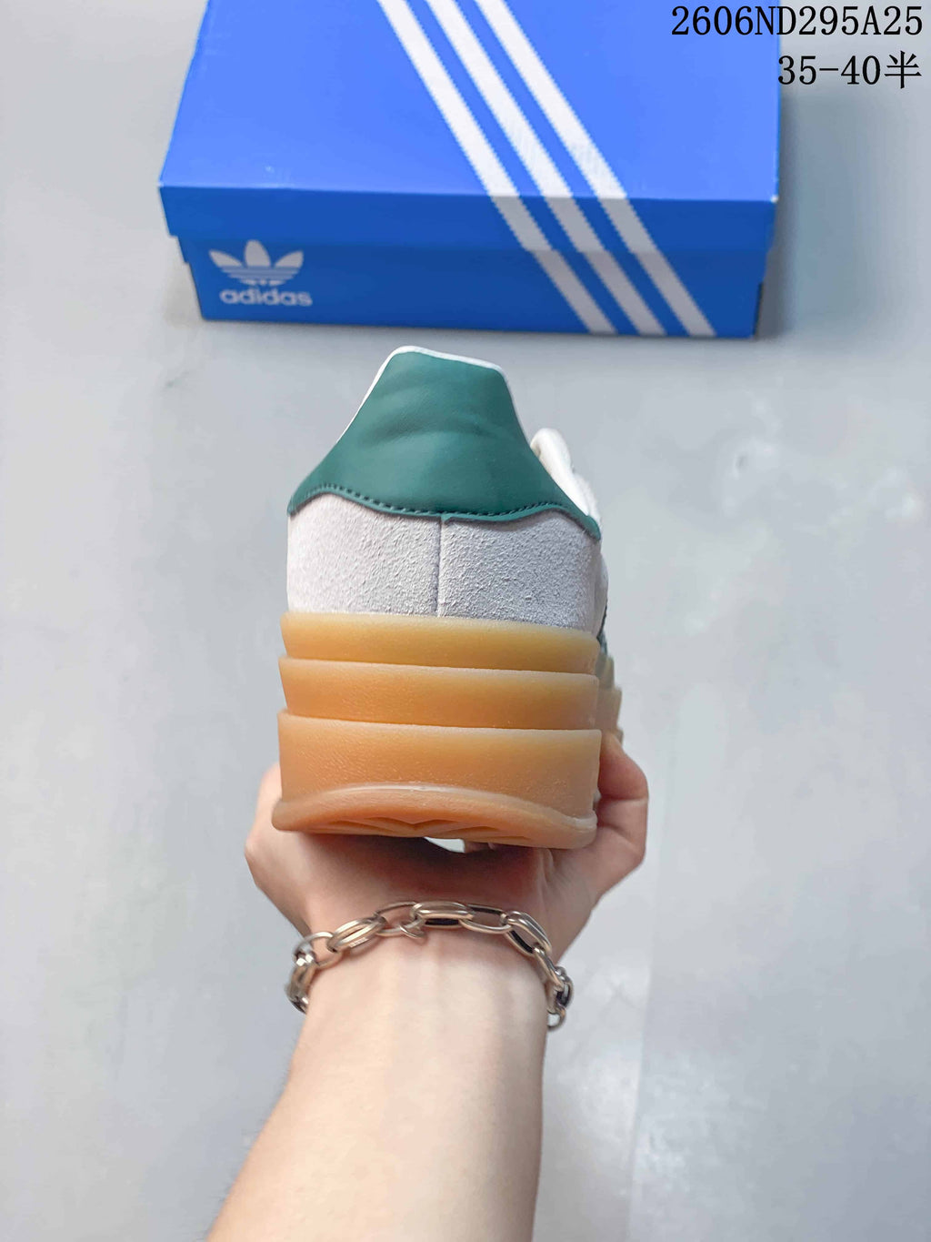 Rear view of the sneaker showing the green heel panel and stacked gum-colored platform sole.