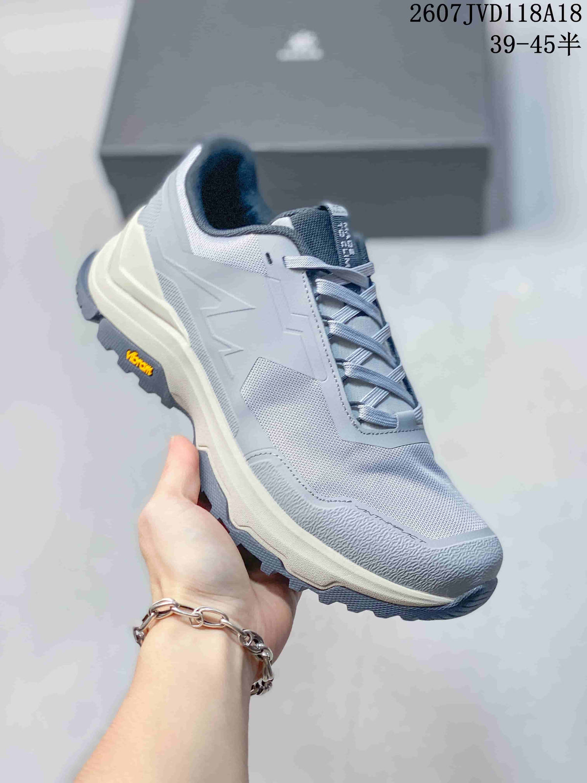 Three-quarter side view of the gray KAILAS sneaker showing the mesh upper, lace system, cushioned midsole, and outsole branding.