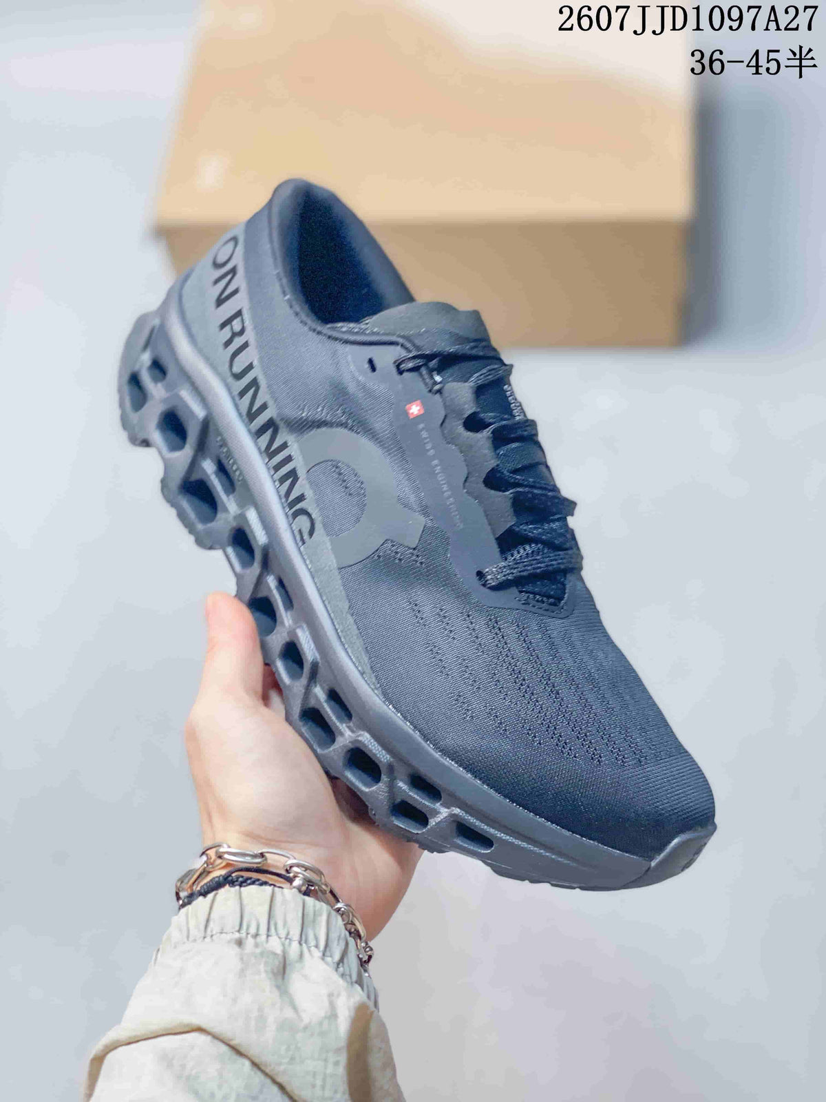 Angled side view of the dark gray On sneaker showing the heel branding, side logo, and sculpted outsole.
