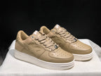 Three-quarter view of the pair showing the beige uppers, star-shaped side details and white soles.