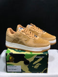 Pair of wheat Bape Sta low-top sneakers displayed on a BAPE camo shoebox; the label shows EU 41, US 8, UK 7 and CM 26 for the photographed sample.