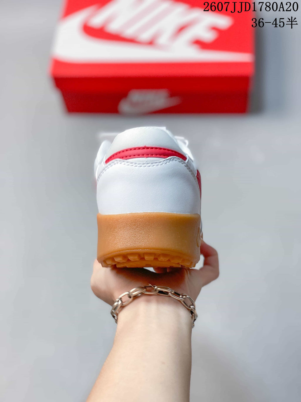 Rear view showing the white heel, red accent detail, and gum-colored outsole.