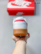 Rear view showing the white heel, red accent detail, and gum-colored outsole.