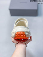 Rear view of the clog sandal highlighting the orange heel tread and raised off-white outsole structure.