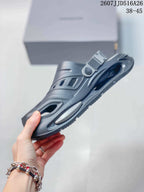 Side view of a dark gray platform clog showing the ventilated upper, heel strap, and thick sole.