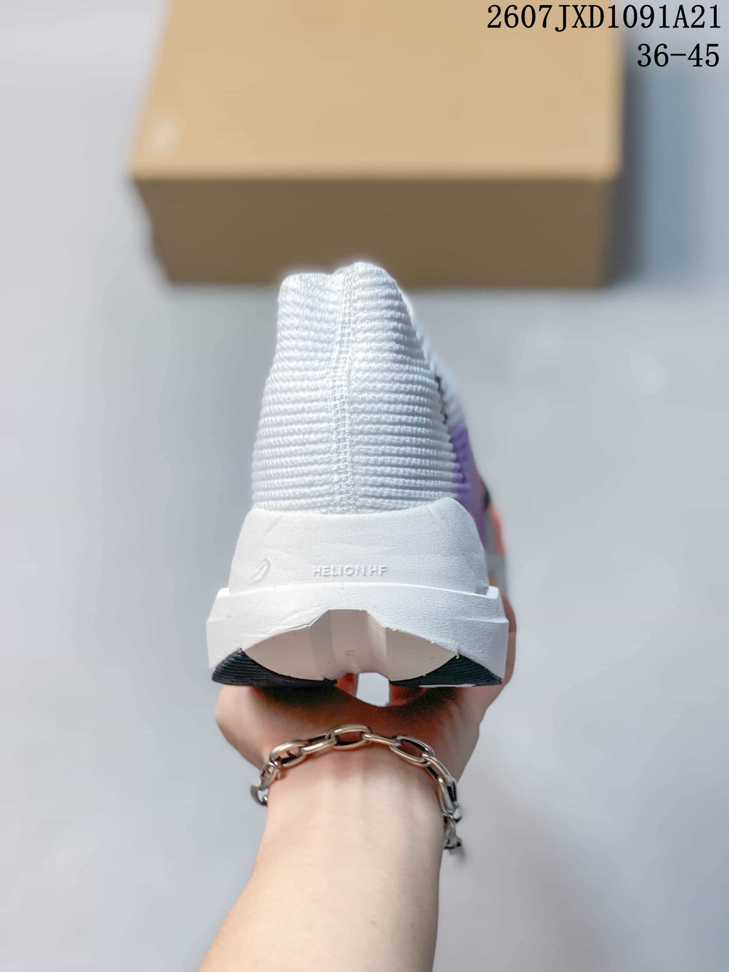 Rear view of the white shoe showing the ribbed upper, raised heel structure, and On branding; image text shows 2607JXD1091A21 and 36–45.