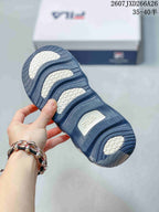 Close-up of the sneaker outsole showing a dark blue tread pattern with contrasting white sections and FILA branding.