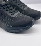 Close-up of the black textured toe and lace area with tonal Alo branding and layered stitching details.