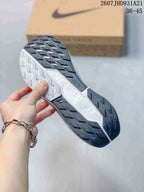 Close-up of the sneaker outsole showing black lugged rubber sections and a contrasting white center section.