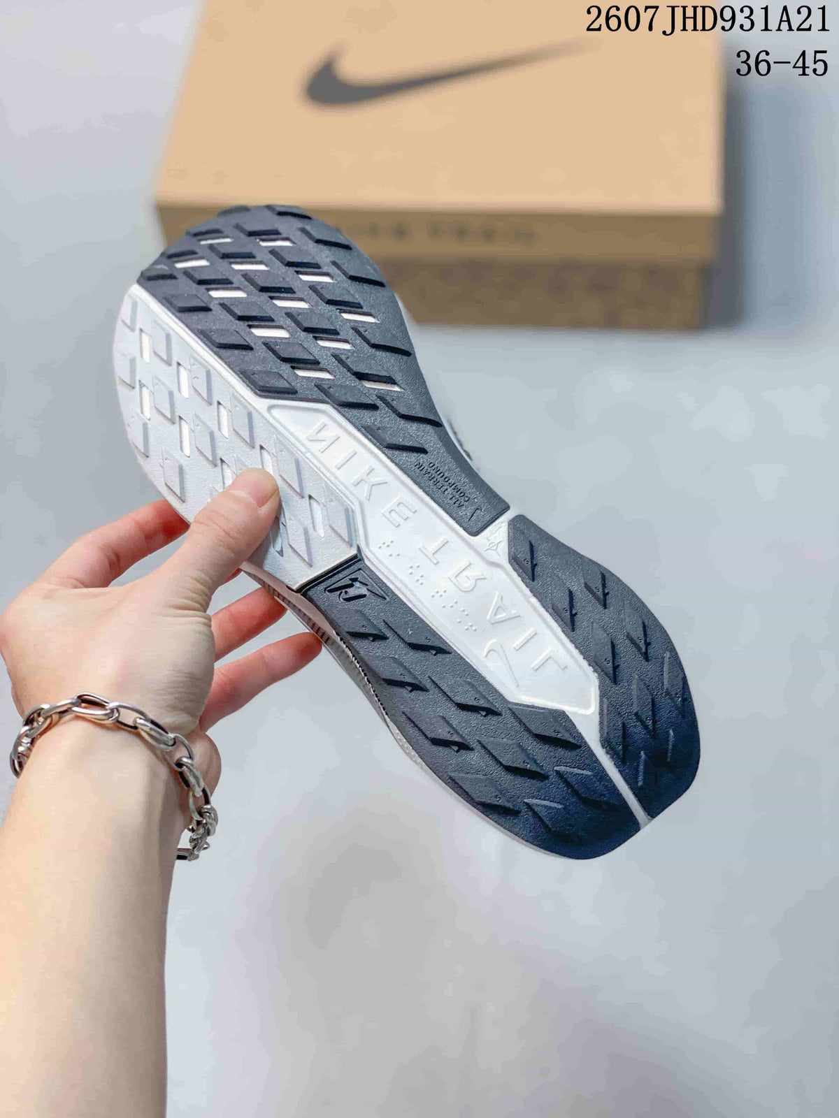Close-up of the sneaker outsole showing black lugged rubber sections and a contrasting white center section.