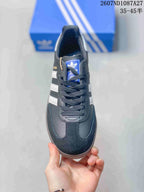 Top view of the sneaker showing black laces, blue adidas tongue label, contrast stitching and rounded toe.