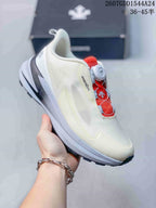 Angled side view of the sneaker showing the off-white upper, red interior accents, BOA dial, and layered sole.