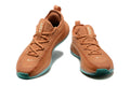 Pair of rust-brown and teal Nike LeBron training shoes shown from the front