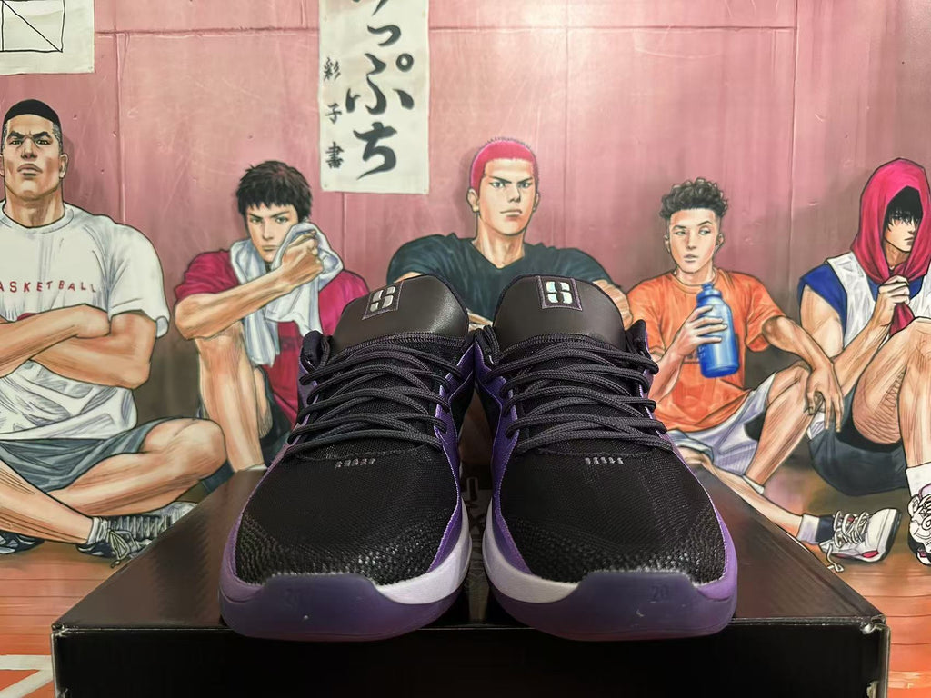 Front view of black Nike basketball shoes with purple accents and black laces.