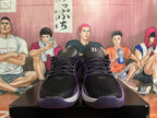 Front view of black Nike basketball shoes with purple accents and black laces.