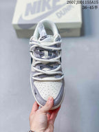 Top view showing the perforated white toe box, gray toe overlay, patterned tongue area, and layered lacing.
