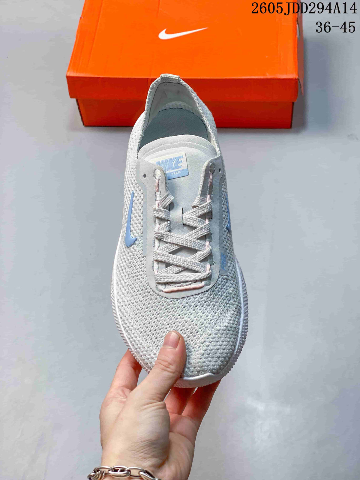 Top view of the light gray knit sneaker showing the rounded toe, laces, tongue, and blue Swoosh detail.