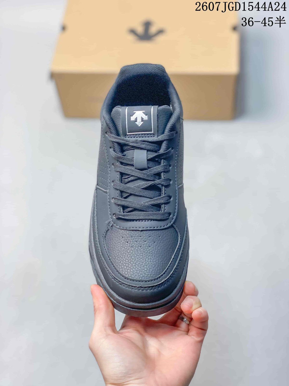 Top view of a black lace-up sneaker showing the padded tongue, perforated toe panel and stitched overlays.
