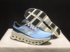Angled view showing the outsole tread, white sole structure, and light blue upper.