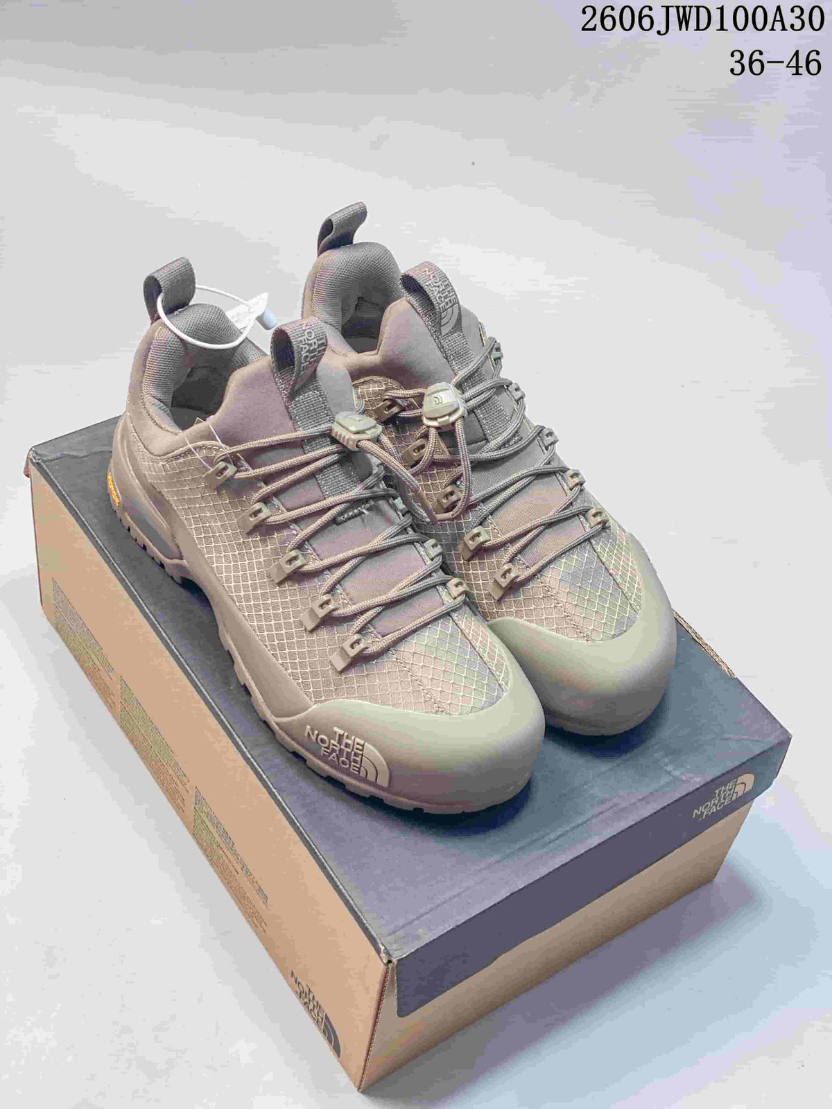 Pair of taupe The North Face Glenclyffe low-top outdoor shoes on a box