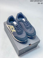 Pair of navy and gold Armani Exchange low-top sneakers displayed on an Armani Exchange shoebox.