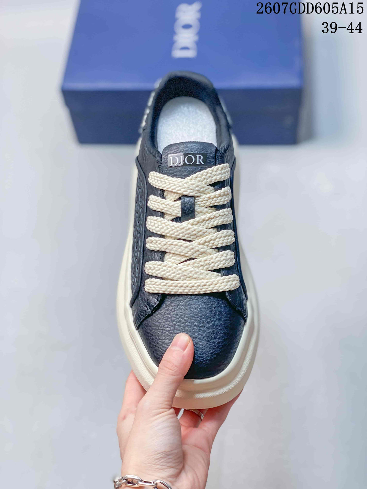 Top view of the sneaker showing the navy toe, cream laces and Dior tongue branding.