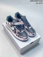 Pair of dark low-top sneakers with a cow-print overlay