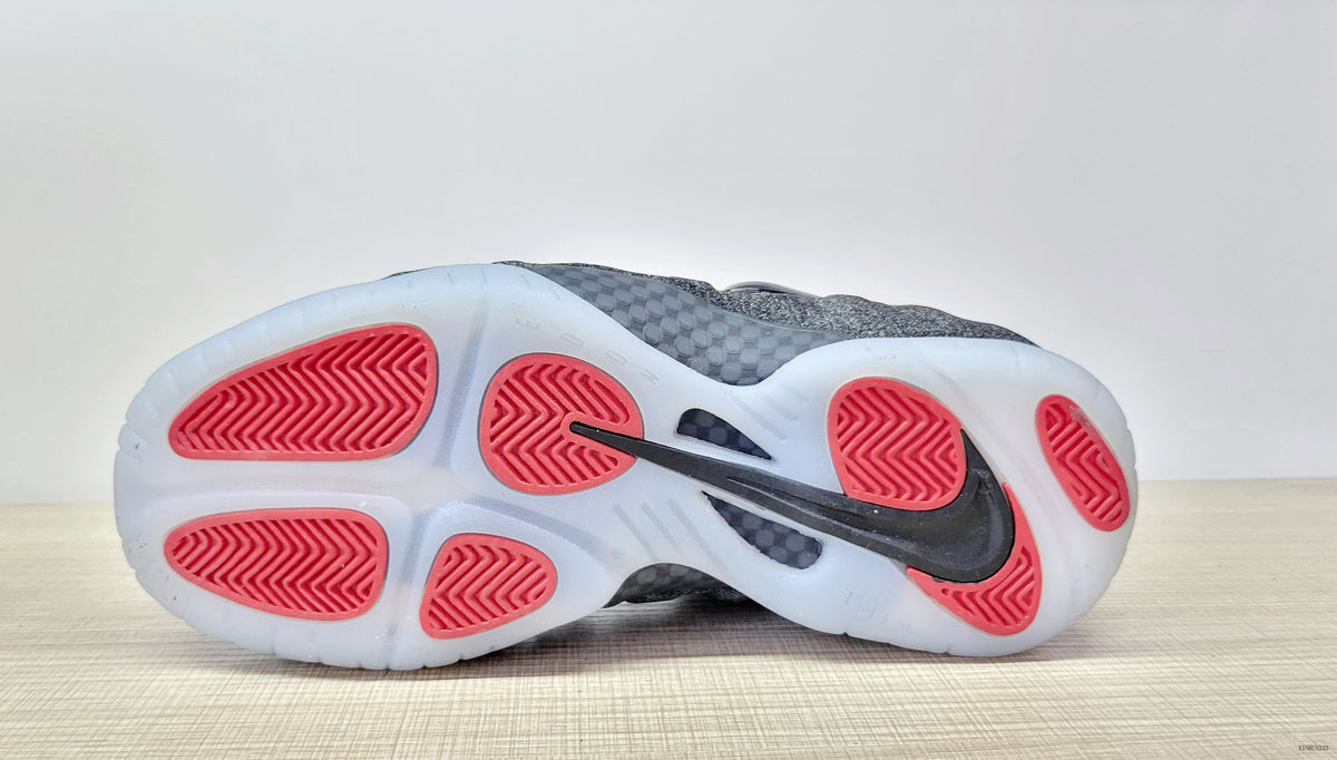 Outsole of the Nike Air Foamposite Pro Fleece sneaker with red traction sections