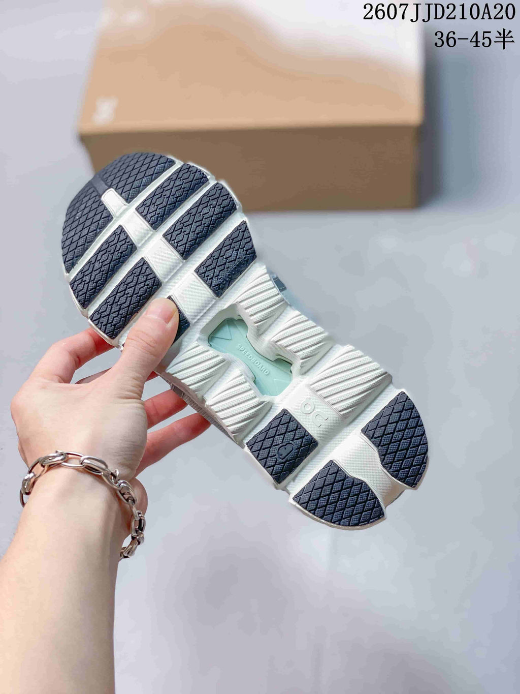 Outsole view showing the segmented white sole and dark textured traction sections.