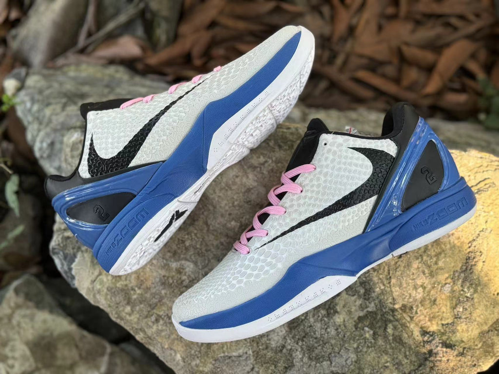 Overhead angled view of both shoes showing their white uppers and blue heel sections.