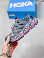 Side profile showing the gray open-sided upper and pink midsole accents.