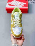 Top view showing the perforated white toe box, yellow overlays, padded tongue, and white laces.