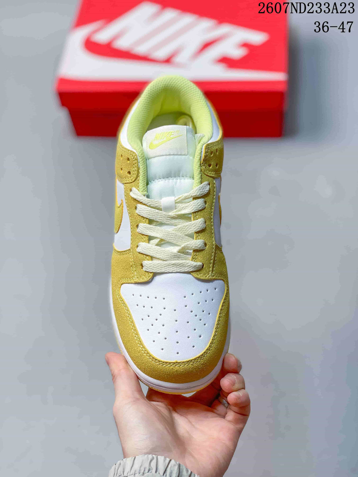 Top view showing the perforated white toe box, yellow overlays, padded tongue, and white laces.