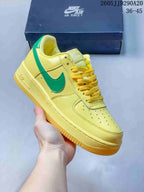 Yellow low-top sneaker with green Swoosh detailing
