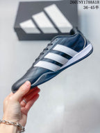 Side profile of a navy adidas sneaker with three white stripes and a contrasting sole.