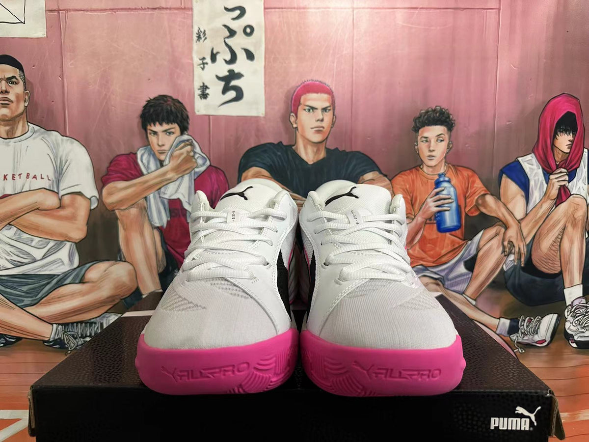 Front view of white PUMA All-Pro basketball shoes with pink toe edges.