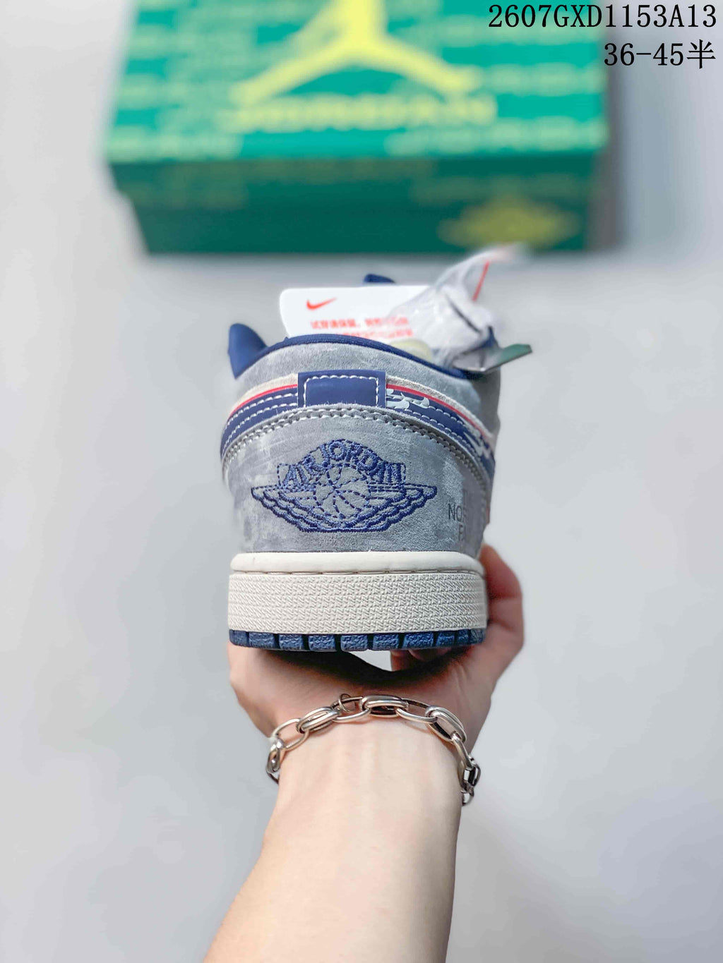 Rear view showing the embroidered winged basketball emblem, blue detailing and white midsole.
