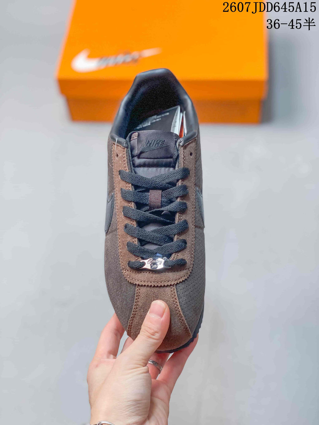 Top view of the sneaker showing the lace-up vamp, tongue branding, contrasting panels, and rounded toe.