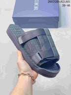 Side view of a grey patterned strap sandal showing its sole and layered upper; image shows size range 39–46.